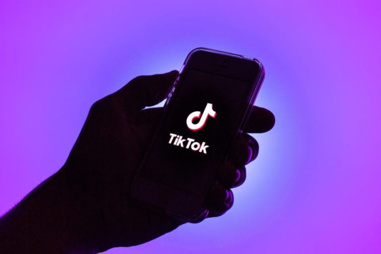 Pessoa segurando celular com o logotipo do TikTok na tela
