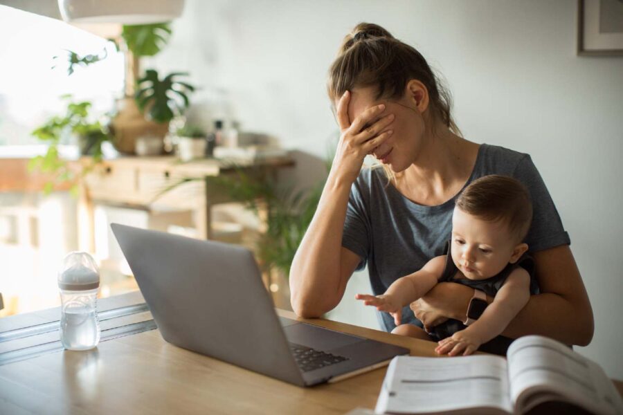 Mãe no trabalho com filho no colo