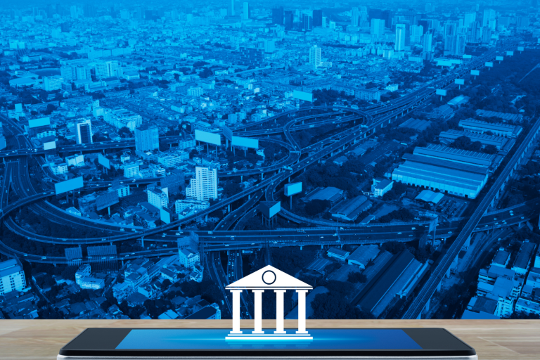 Ilustração de uma cidade tecnológica com um ícone bancário ao centro da imagem. Foto: Canva Images
