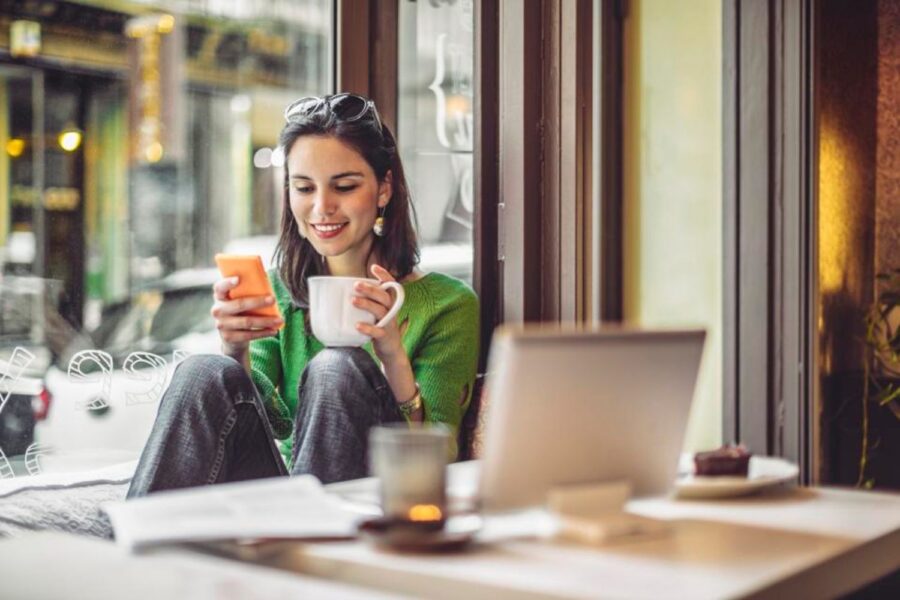 Mulher da geração Z sentada em café com computador